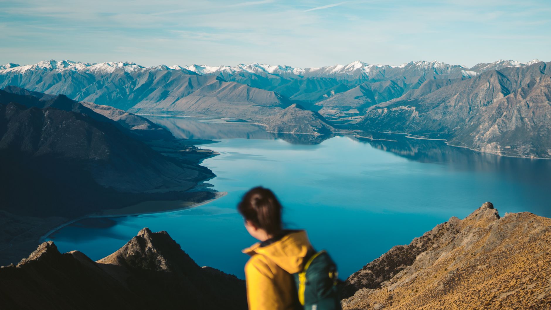 Hiker looking across dramatic New Zealand valley
