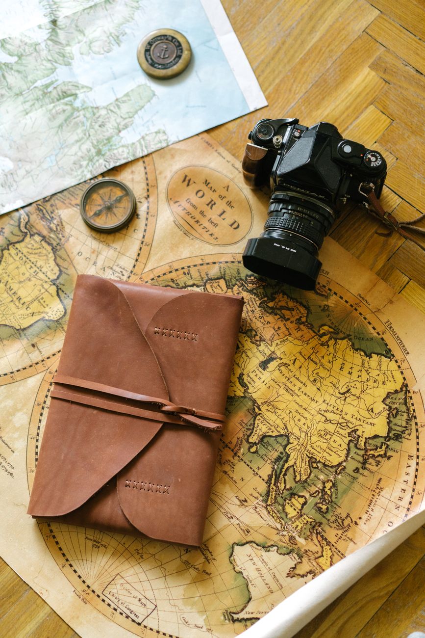 Custom route planning map and compass on wood table